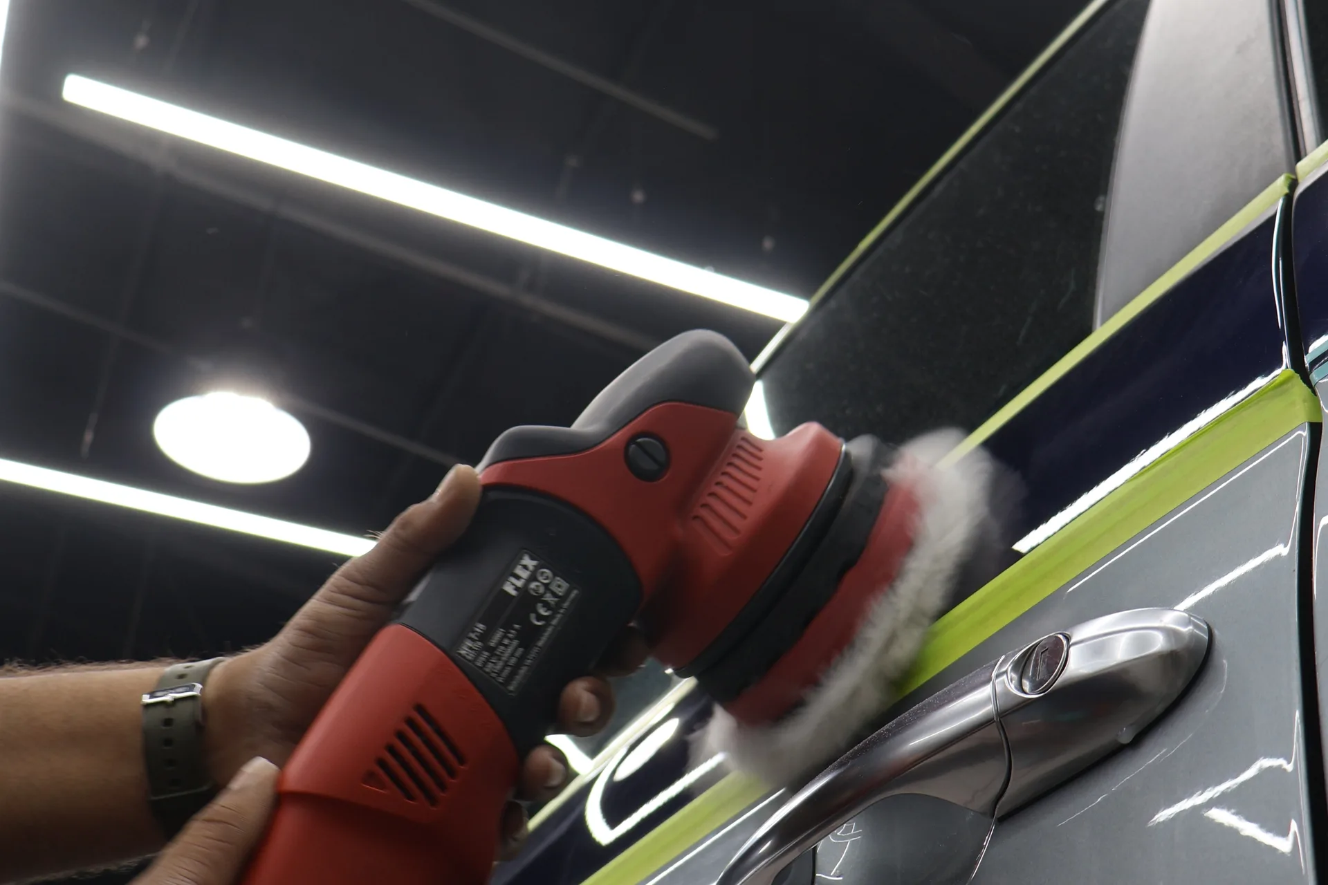 Technician performing paint correction with dual-action polisher