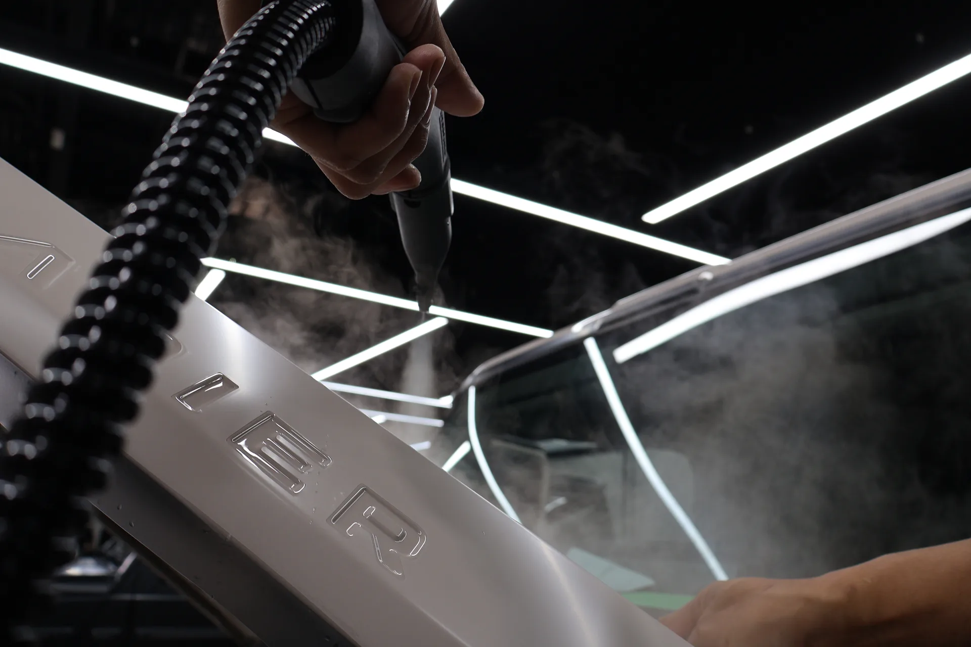 Steam cleaning process on vehicle exterior